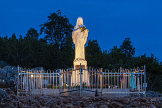 Image of the Marian Shrine lit up at night.